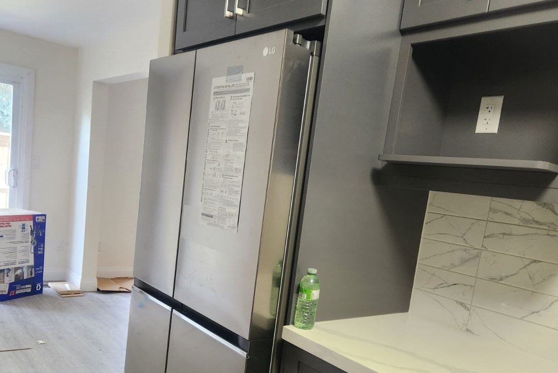 Kitchen With Fridge And Small Counter